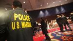 A U.S. Marshal looks on an auction in 2009 in New York City.