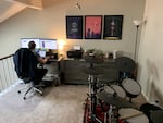 Kevin Dole works from home next to his wife's bureau and near his drum set in the couple's small two-bedroom condo in Nashville, Tennessee.