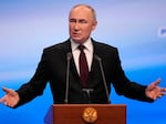 Russian President Vladimir Putin gestures while speaking on a visit to his campaign headquarters after a presidential election in Moscow, Russia, early Monday.