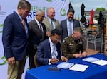 Norfolk Mayor Kenny Alexander signs a Project Partnership Agreement for the floodwall project with Col. Brian Hallberg, commander of the Army Corps' Norfolk District, in June.