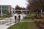 Students walk across Portland Community College's Southeast campus on a rainy day in December 2015.