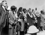 Civil rights demonstrators, led by Dr Martin Luther King (5th R), civil rights activist Ralph Abernathy (5th L), John Lewis (3rd L) and other civil and religious leaders, make their way from Selma to Montgomery on March 22, 1965 in Alabama.