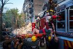 Rescue workers evacuate an injured man from a multi-story residential house destroyed by a Russian strike in Kyiv, Ukraine, on Tuesday.