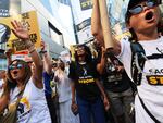 People hold signs as members of SAG-AFTRA and Writers Guild of America East walk a picket line outside of the HBO/Amazon offices during the National Union Solidarity Day in New York City on Aug. 22, 2023. Labor unions have notched some big victories this year but organized labor still faces an uncertain future.