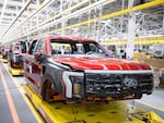 Ford F-150 Lightning pickup trucks sit on the production line at the Ford Rouge Electric Vehicle Center in Dearborn, Mich., on April 26, 2022. Ford is willing to sell the electric version of its top-selling model at a loss for now in order to gain market share.