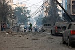 Sun., Oct. 8: Residents check the damage following Israeli air strikes in Gaza City.