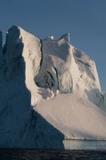 The sunset reflects off of an iceberg in Ilulissat.