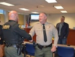 Deschutes County Sheriff's Office Capt. Ty Rupert, center, shakes hands with a colleague after the county commission appointed him on July 29, 2025, to serve as interim-sheriff. Rupert will replace outgoing sheriff Kent van der Kamp, who resigned.