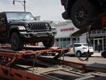 Jeeps are delivered to a dealership in Chicago on June 20, 2024. Stellantis, the parent company of Jeep, reported disappointing earnings for the first half of 2024. 