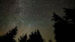 In this 30 second exposure, a meteor streaks across the sky during the annual Perseid meteor shower, Wednesday, Aug. 11, 2021, in Spruce Knob, West Virginia.