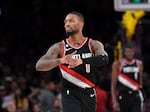 Damian Lillard of the Portland Trail Blazers taps his wrist signifying "Dame Time" after a clutch three-point basket in the closing seconds against the Los Angeles Lakers on Oct. 23, 2022.
