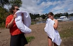 From left, Abby Hall and Stella Krakow inflate their floats on Elk Rock Island. 