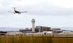 FILE - In this July 13, 2014, file photo, a plane lands at Portland International Airport in Portland, Ore.
