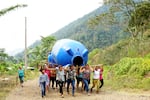 In this 2023 supplied photo, women in El Volcán, Nicaragua, carry a water tank to be installed to store and treat clean drinking water for the community. Green Empowerment, a Portland-based nonprofit, helped with the clean water project.