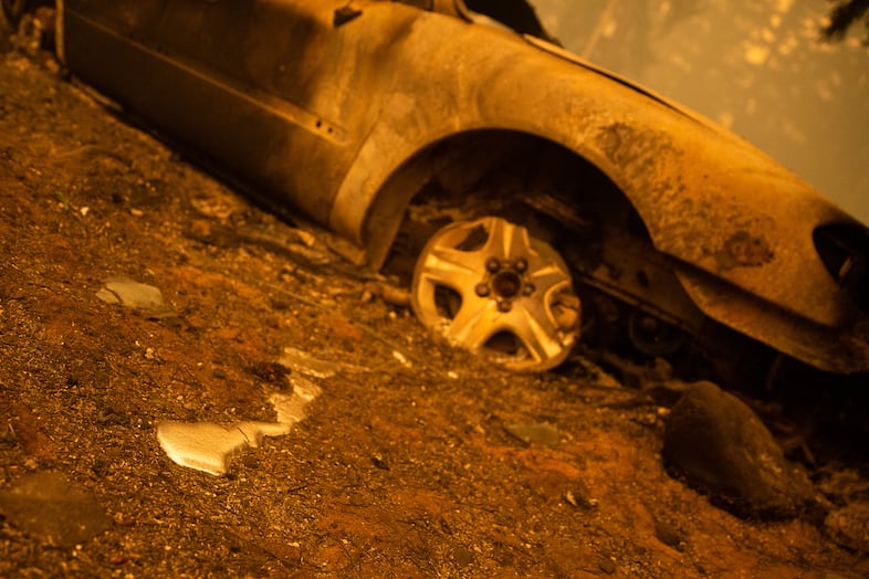 Liquid spills from a vehicle destroyed in the Santiam Fire near Gates, Ore., Sept. 9, 2020.