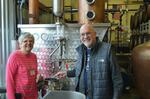 Dorie and John Belisle at their BelleWood Acres apple orchard, which also operates a distillery.