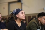 A high school student sits in the audience for a "Think Out Loud" live show on race in education. 