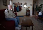 A man sitting on a couch in his living room.