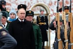 Russian President Vladimir Putin takes part in a wreath-laying ceremony at the Tomb of the Unknown Soldier in Alexander Garden on Defender of the Fatherland Day, in Moscow, Friday.