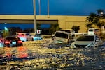 Cars drive in a flooded street following heavy rains in Dubai on Wednesday. Torrential rain caused floods across the United Arab Emirates, Bahrain and Oman.