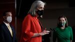 Rep. Katherine Clark, D-Mass., meets with reporters before the House votes to pass a $1.9 trillion pandemic relief package in 2021. Speaker of the House Nancy Pelosi, D-Calif., right, and Rep. Pete Aguilar, D-Calif., listen.