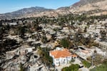 A lone home stands among residences leveled by the Eaton Fire in Altadena, Calif., Jan. 21, 2025.