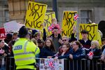 Protesters wait for the arrival of King Charles III and Camilla, the queen consort, in Liverpool, England, on April 26. Dissenters will be among the cheering crowds when Charles travels to his coronation. More than 1,500 protesters will be dressed in yellow for maximum visibility, and they plan to gather along the parade route to chant "Not my king" as the royal procession goes by.