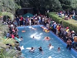 Protesters demanding the resignation of Sri Lanka's President Gotabaya Rajapaksa swim in a pool inside the compound of Sri Lanka's Presidential Palace in Colombo on July 9, 2022.