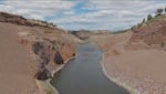 In this screenshot from drone footage taken on June 22, the Paddle Tribal Waters group of kayakers paddle through the Iron Gate Dam site in Northern California.