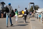 Haitian citizens cross over the border from the Dominican Republic into Haiti on Wednesday.