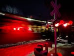 (Click photo to see related Oregon Field Guide episode) The Sumpter Valley Railroad's Christmas train roars through a road crossing on a cold December night in 2021. 