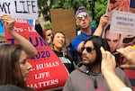 A small group of anti-abortion activists rallies on May 21, 2019, in Portland, Ore. The group held their demonstration as thousands of people also gathered in the Oregon city to protest recent abortion bans in eight states.