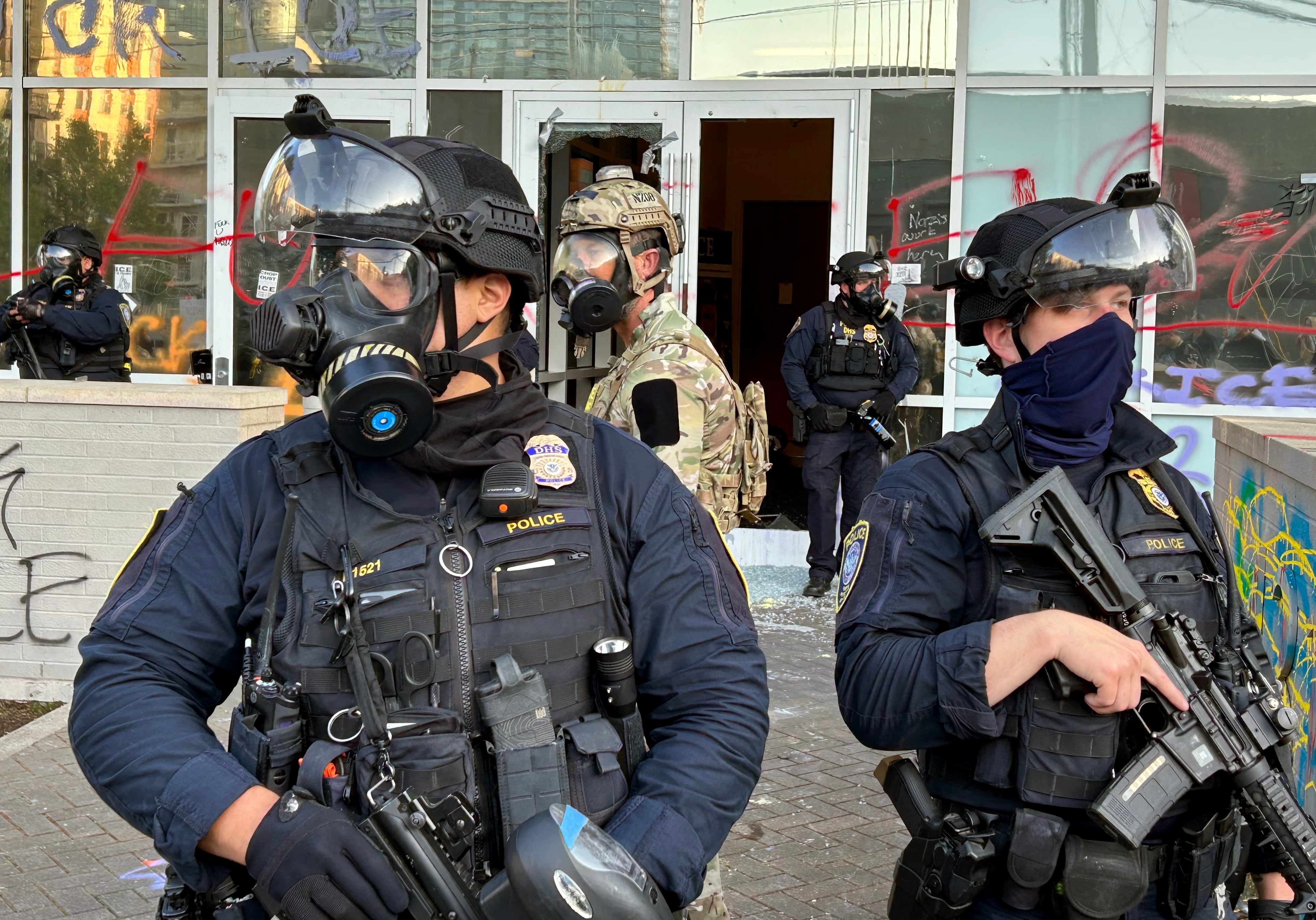 Federal officers guard the entrance to the ICE facility in SW Portland on June 14, 2025. Earlier in the evening, DHS officers clashed with protesters, firing crowd control munitions into the crowd, which threw objects back at the building. After some attempts, protesters eventually broke through the front door to the facility.