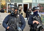 Federal officers guard the entrance to the ICE facility in SW Portland on June 14, 2025. Earlier in the evening, DHS officers clashed with protesters, firing crowd control munitions into the crowd, which threw objects back at the building. After some attempts, protesters eventually broke through the front door to the facility.