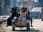 Displaced Palestinians travel on a cart in Rafah, southern Gaza Strip, on May 7.