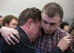 Micah Fletcher, right, comforts someone inside the courtroom during closing arguments at the Jeremy Christian trial in Portland, Ore., on Wednesday, Feb. 19, 2020.