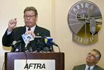 FILE - Former Congressman Esteban Torres, Chair of the Latino Media Council, at podium, expresses the improved but still very incremental performance by the four television networks in diversifying their workforce and increasing minority vendor contracts during a news conference at the American Federation of Television and Radio Artists (AFTRA ) offices in Los Angeles on Nov. 18, 2004. Esteban Torres, an eight-term congressman from Southern California who fought for social and economic change to help empower Latinos, has died at 91 on Tuesday, Jan. 25, 2022.  At right, Alex Nogales President and CEO of the National Hispanic Media Coalition (NHMC).