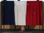 A voter stands in the polling booth during the second round of the legislative elections in Le Touquet-Paris-Plage, northern France, on Sunday. 