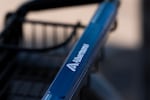 FILE - Branding for Albertsons grocery store is seen on a shopping cart on Monday, Aug. 26, 2024, in Lake Oswego, Ore. Washington is suing the company for what it calls "deceptive" buy one, get one free sales.