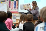A kindergarten teacher reads the book "Dumpling Soup" to her young students, incorporating Asian American and Pacific Islander subjects in her class.
