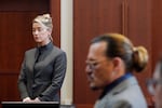 Actors Amber Heard and Johnny Depp watch as the jury leaves the courtroom at the Fairfax County Circuit Courthouse in Fairfax, Va., on May 16. Depp sued Heard, his ex-wife, for libel after she wrote an op-ed piece in The Washington Post in 2018 titled,  "I spoke up against sexual violence — and faced our culture's wrath. That has to change."