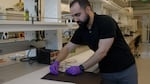 University of Washington assistant professor Mohammad Malakooti demonstrates the conductivity of the gallium/indium metal mixture he’s used to create liquid “wires” in this video still taken in March, 2024. The liquid metal flexes and stretches inside his new wearable thermoelectric device.