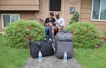 The Johnsons sit outside of their house in Southeast Portland with their cat. One of their main concerns going into the earthquake simulation was whether or not they would have enough cat food in their household.