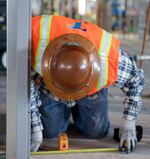 Construction worker installs the interior wiring, ducting and other technologies that were designed before construction in a computer. Developers say savings helped them add 40,000 sq ft.