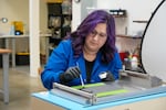 Madison McCleary, vice president of engineering at Skip Technology, prepares carbon paper for coating during a test at the startup's Portland, Ore., office on April 3, 2024. Skip and the Puyallup Tribe are partnering to build large flow batteries to store energy from intermittent sources like wind and solar.