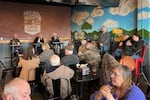 A community member (right) speaks during a recent Coos Bay town hall meeting at a local restaurant.