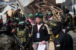 Palestinian militants escort Israeli-American hostage Sagui Dekel-Chen (C) before handing him over to a Red Cross team in Khan Yunis in the southern Gaza Strip on February 15, 2025, as part of the sixth hostage-prisoner exchange. Masked militants handed over three Israeli hostages to the Red Cross in Gaza on February 15, in the sixth hostage-prisoner swap under its ceasefire agreement with Israel, an AFP journalist reported. (Photo by Eyad BABA / AFP) (Photo by EYAD BABA/AFP via Getty Images)