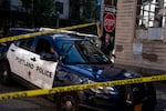 A Portland police officer lets a police car through caution tape blocking off the area surrounding the U.S. Immigration and Customs Enforcement building before U.S. Department of Homeland Security Secretary Kristi Noem visits to Portland on Tuesday, Oct. 7, 2025.
