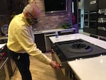 Basco Appliances General Manager Fred Graetzer lights the burner on a gas stove in the store's Northwest Portland showroom.