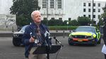 Oregon Senate President Peter Courtney, D-Salem, holds up a smartphone at a state capitol press conference. 